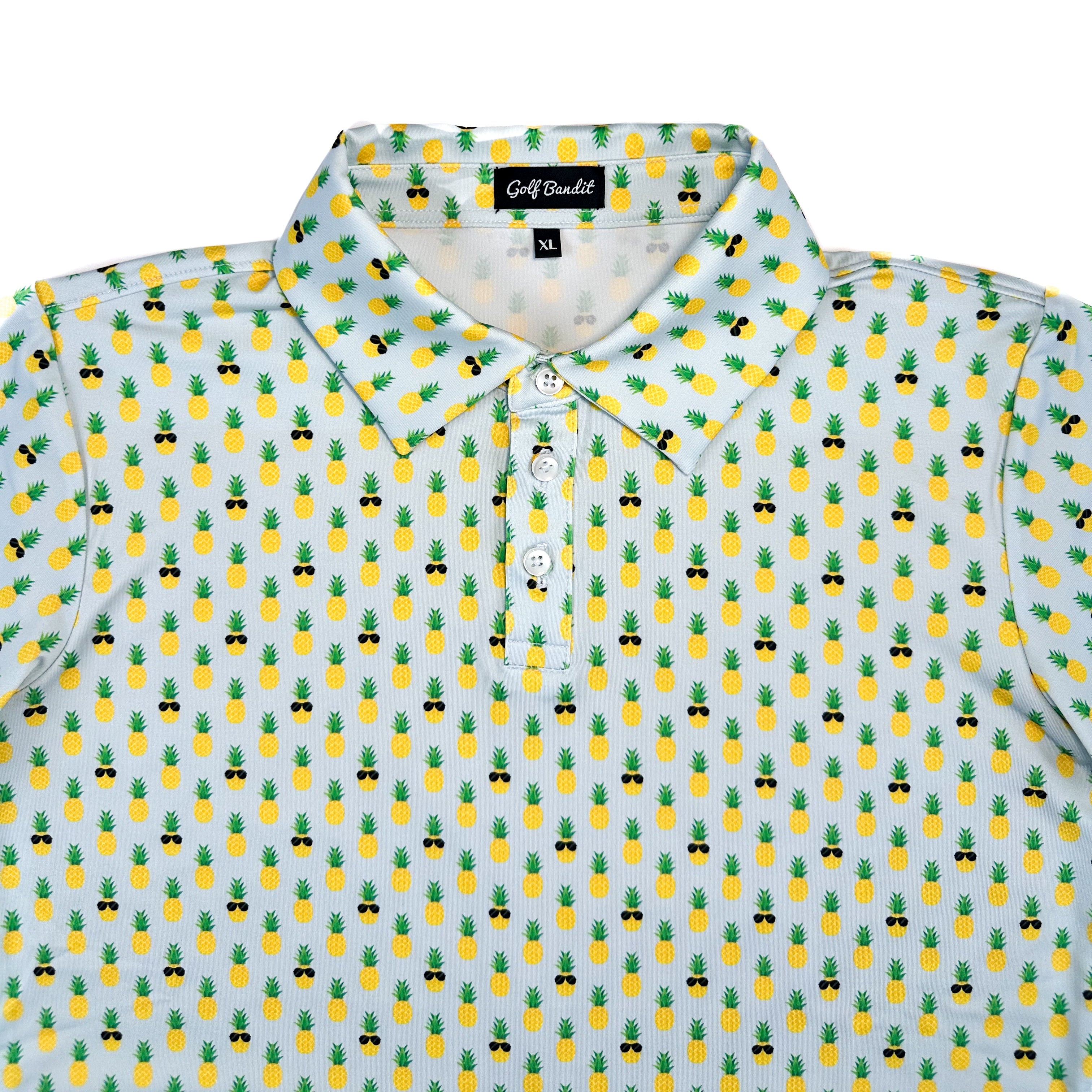Close-up of La Piña Girls Junior Golf Polo collar in light blue with playful pineapple print, showcasing moisture-wicking fabric, SPF 50 protection, wrinkle-resistance, and 4-way stretch. Perfect junior golf clothing for girls aged 8-14. Golf Bandit Junior Golf Polos are the best quality in US Kids Golf apparel.