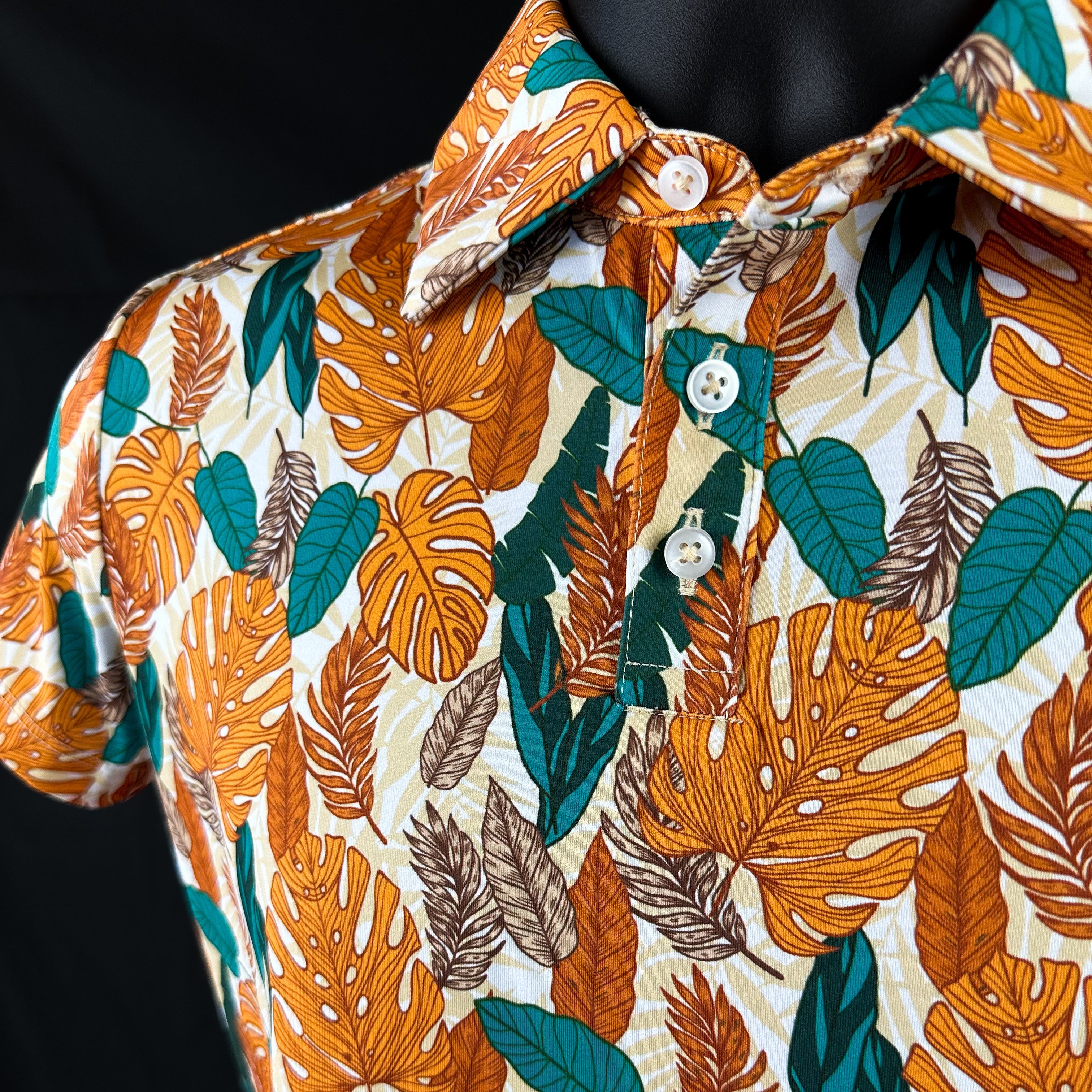 Close-up of Paradise Greens Girls Junior Golf Polo in a vibrant leafy design, showcasing moisture-wicking fabric, SPF 50 protection, wrinkle-resistance, and 4-way stretch. Perfect junior golf clothing for girls aged 8-14. Golf Bandit Junior Golf Polos are the best quality in US Kids Golf apparel.