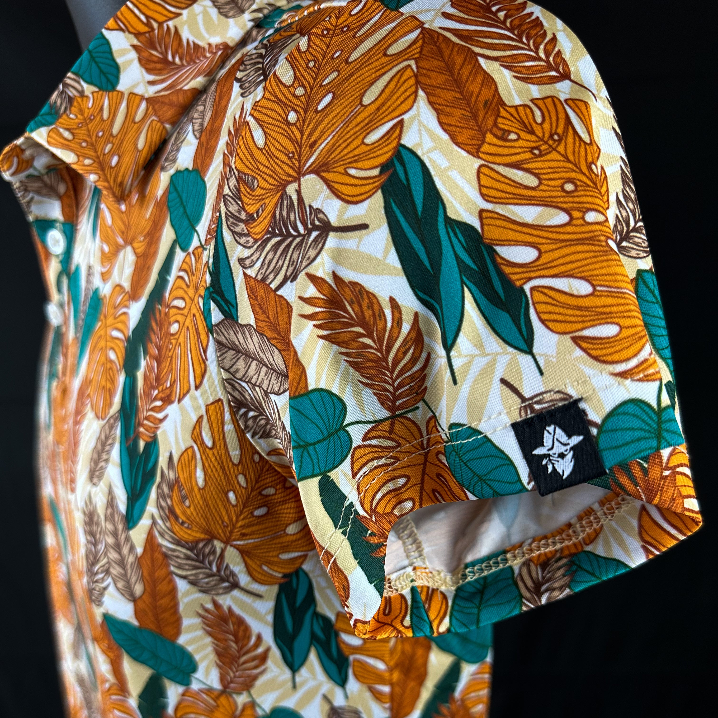 Side view of Paradise Greens Girls Junior Golf Polo in a vibrant leafy design, showcasing moisture-wicking fabric, SPF 50 protection, wrinkle-resistance, and 4-way stretch. Perfect junior golf clothing for girls aged 8-14. Golf Bandit Junior Golf Polos are the best quality in US Kids Golf apparel.