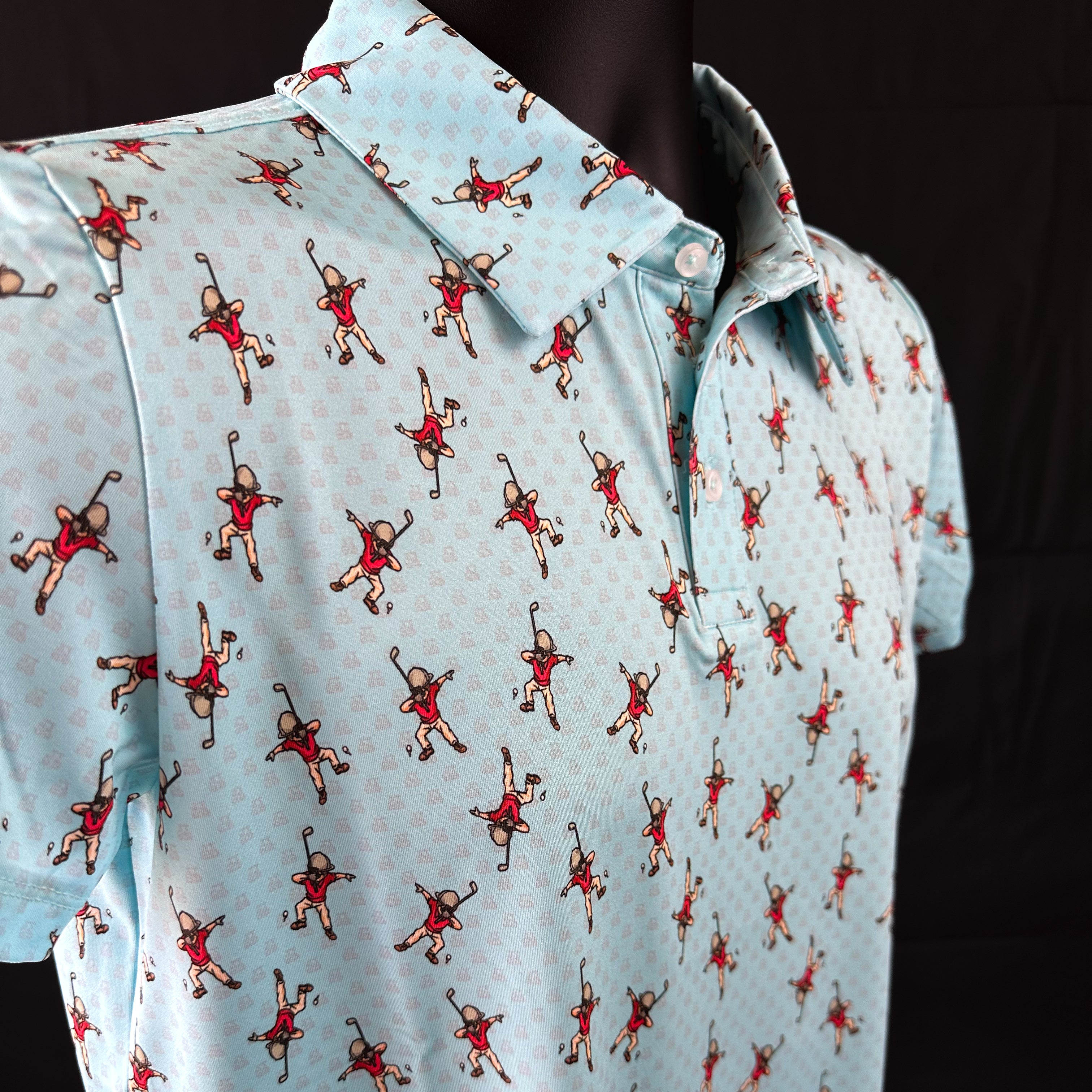 Side view of Dapper Dab Boys Junior Golf Polo in light blue with playful dabbing golfer print, showcasing moisture-wicking fabric, SPF 50 protection, wrinkle-resistance, and 4-way stretch. Perfect junior golf clothing for boys aged 8-14. Golf Bandit Junior Golf Polos are the best quality in US Kids Golf apparel.